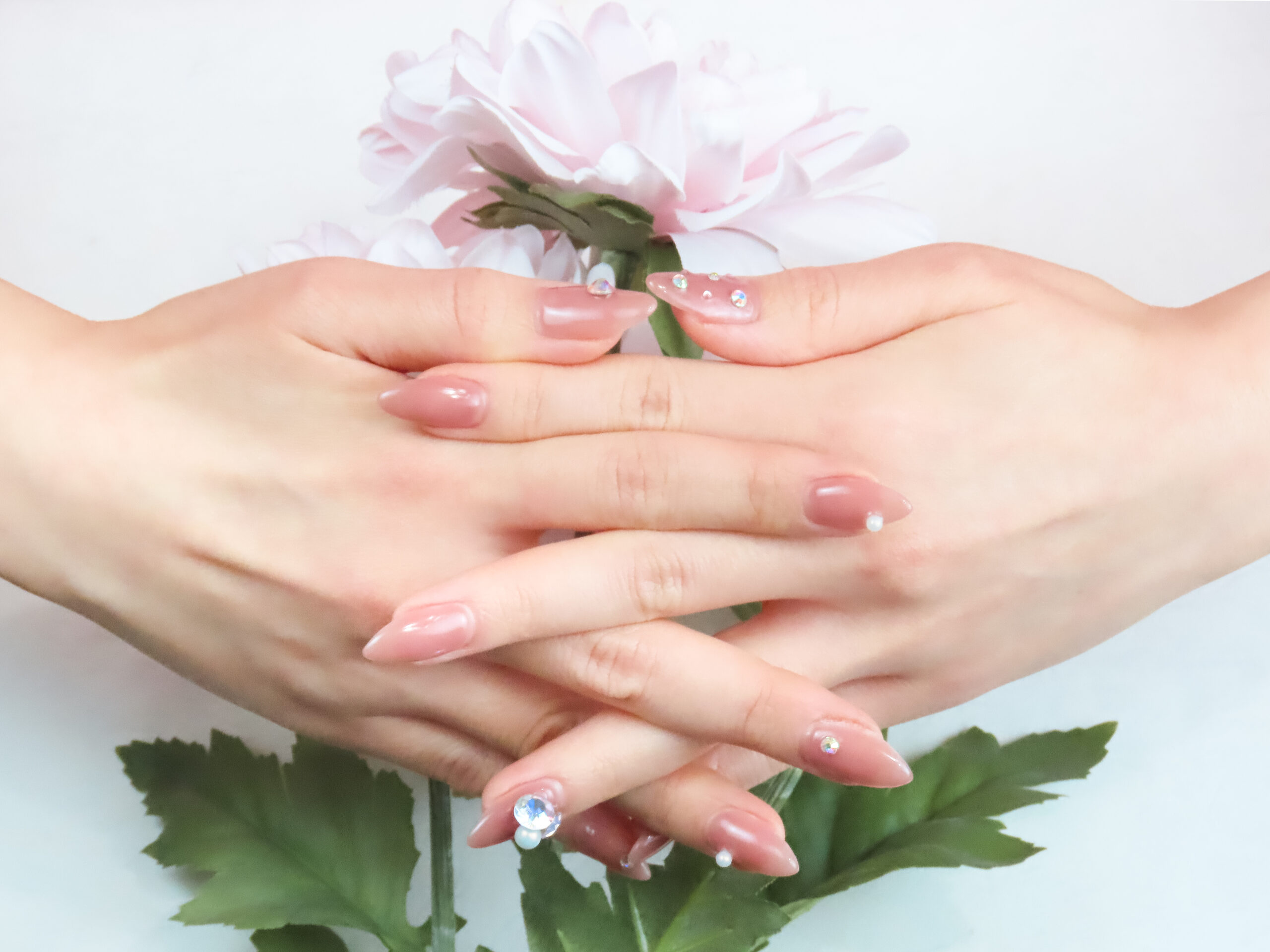 Soft pink gel manicure with small gems